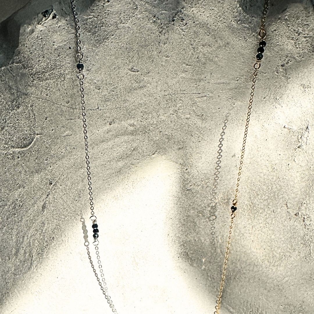 Sparkling sapphire gemstone chain with dainty flat cable links, customizable for elegant and practical jewelry designs.